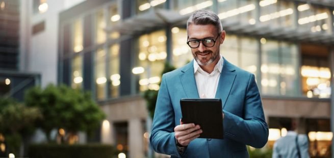 Mature, business and man with tablet outdoor for communication, research and typing email on website. Professional, male manager and digital for networking, contact and task management in urban city